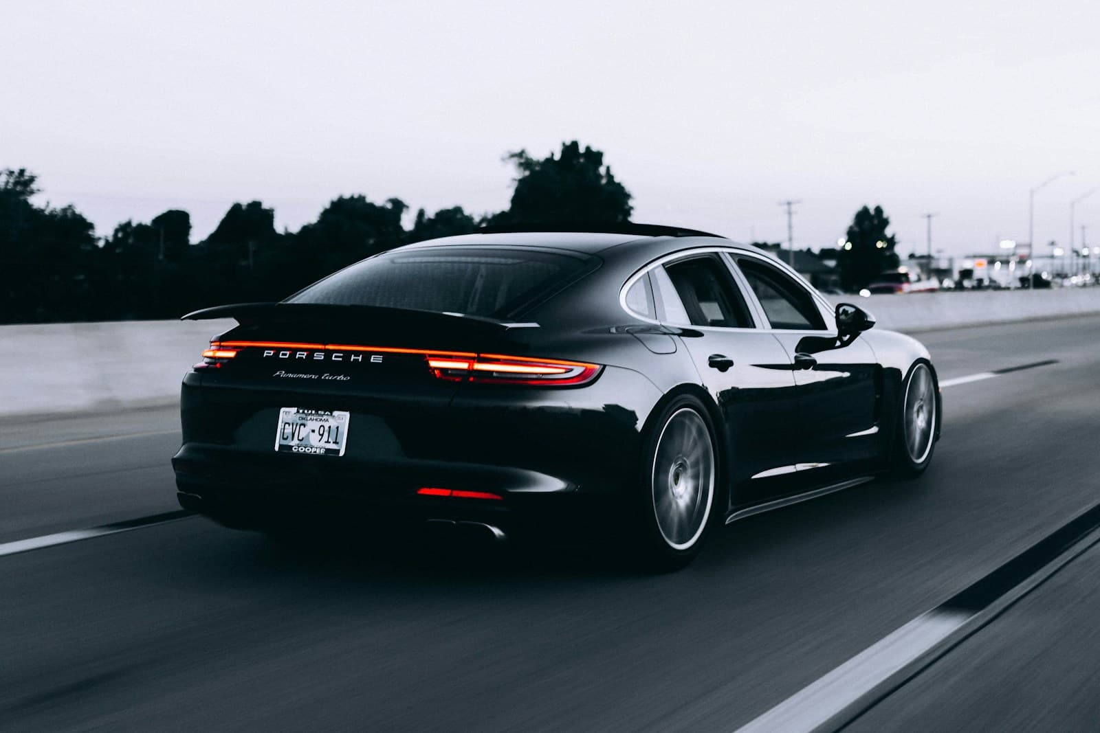 Dark Porsche driving on a motorway